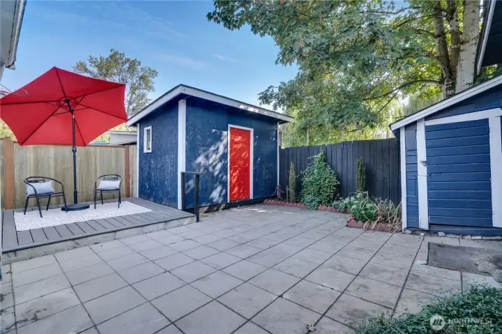 Designed for gatherings and outdoor enjoyment, the private backyard features a spacious patio and raised deck—offering multiple zones for entertaining, dining, and relaxing in a fully fenced setting.