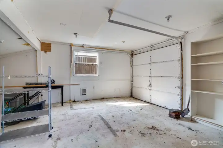 Built-in shelving in the spacious one-plus car garage makes it easy to stay organized—keeping tools, gear, and everyday items neatly tucked away.
