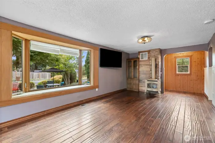 Large bay window overlooks patio space.