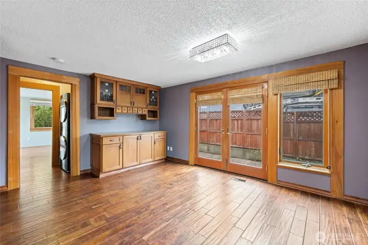 Classic french doors open to side patio area. Built-in cabinetry offers additional storage.