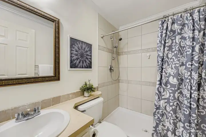 Primary bathroom with updated tile backsplash and walk-in shower