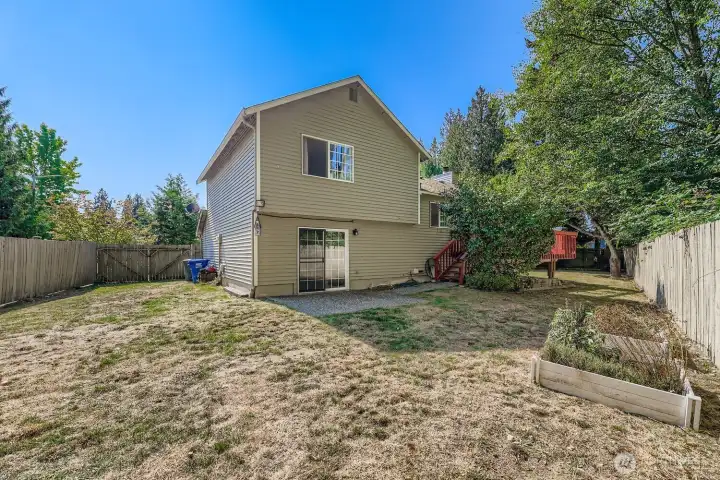 Big fenced yard that backs up to private greenbelt with fruit trees, outdoor garden shed