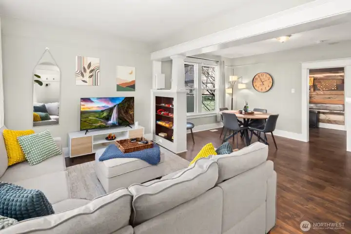 Unit #2015: view from the entryway - note the original built-ins and columns, and space to flex between living and dining areas.