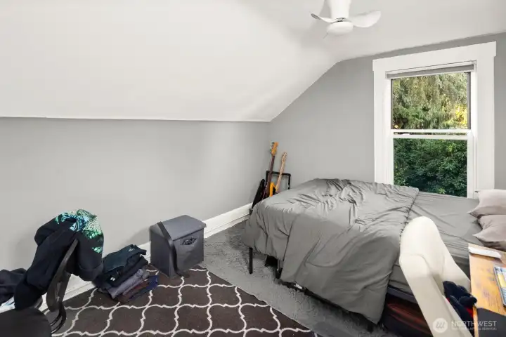 Unit #2011: The third, rear bedroom is adjacent to the bathroom, and also looks out over the lush green yard.