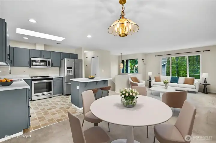 Open kitchen with dining area and living room. Virtually staged.
