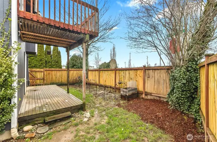Side yard with deck and patio space.