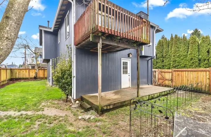 View of the backyard from the side yard. Newer fully fenced backyard.