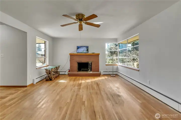 Living room with cozy brick fireplace and open layout.