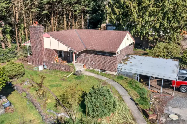 Not only is there a large 2-car carport, there is an additioanal 2-car garage under the home. One of the bays of the garage were used as a large shop area.