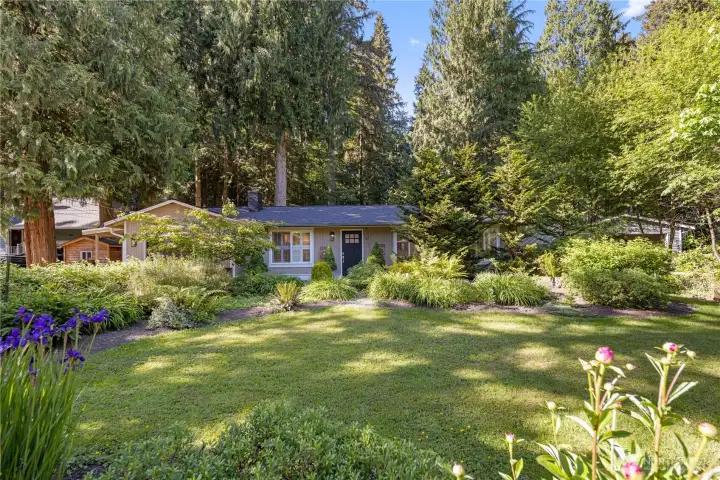 This home is a beautiful oasis in side and out. Walk-worthy gardens with meandering paths await your delight, in both front yard and back! Some well placed landscape lights assure you never lose your way. This Craftsman-style one level home creates picturesque curb appeal, framed by lattice fencing, beautiful front yard gardens, classic shutters, and a peaceful Lake Marcel neighborhood setting.