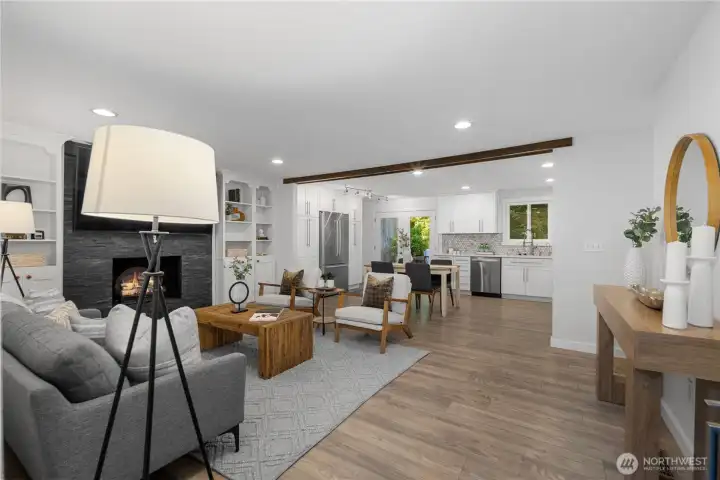 Recessed lighting provides even light throughout the living, dining, and kitchen spaces, while new warm-tone bulbs add a gentle glow that keeps the open interior feeling bright, calm, and beautifully cohesive from room to room.