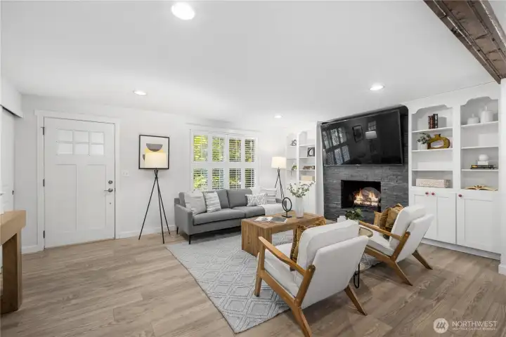 Classic shutters give the windows a timeless, tailored look that is repeated throughout the home, creating a sense of continuity from room to room. Generous windows, along with the glass panel above the front door,  bring in natural light that keeps the living space feeling bright, open, and welcoming.