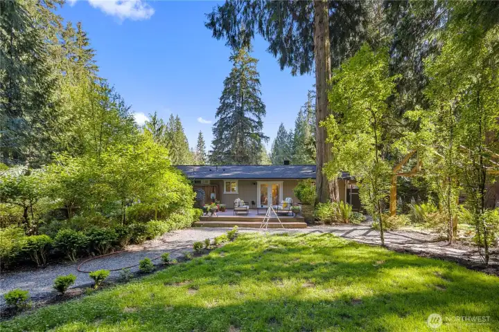 Wiring to the left of the deck offers the option to add a hot tub and create a private backyard spa experience. Tucked into the garden setting with the deck just steps away, it would be a natural place to unwind at the end of the day.
