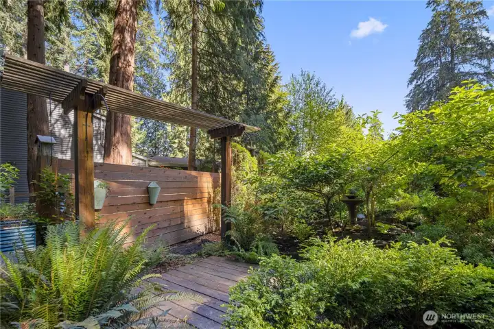 Enjoy watching wildlife in your own backyard, where chickadees nest in the bird houses and robins nest nearby in the arborvitae. A beautiful cement bird bath fountain hides here in the garden for bird watching delight. This is one of two small additional decks creating quiet places to sit, observe, and take in the gentle activity of the landscape, or to chase the sun and absorb it's warmth.