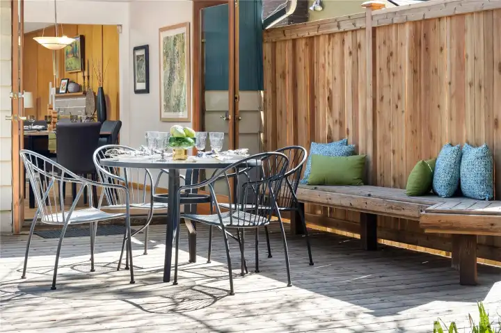 Lovely private deck off of dining room. Built-in bench provides extra seating.
