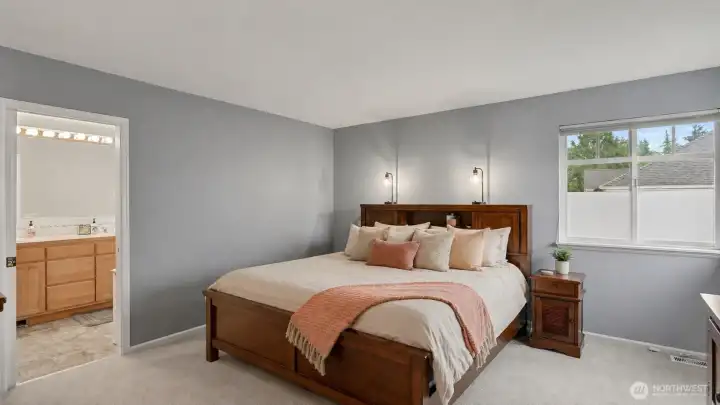Roomy primary suite -bedding virtually staged