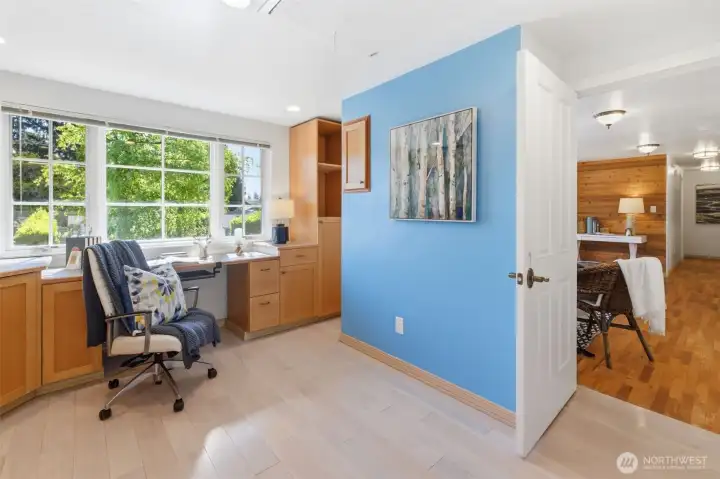 This space is just around the corner from the living room fireplace. It was designed as an ultra-deluxe arts and  crafting center with wonderful lighting and space. It can serve as cheerful expansive home office, has multi-use possibilities.  With a little re-arranging, can create a guest room independently located from other bedrooms and still have a large laundry room.
