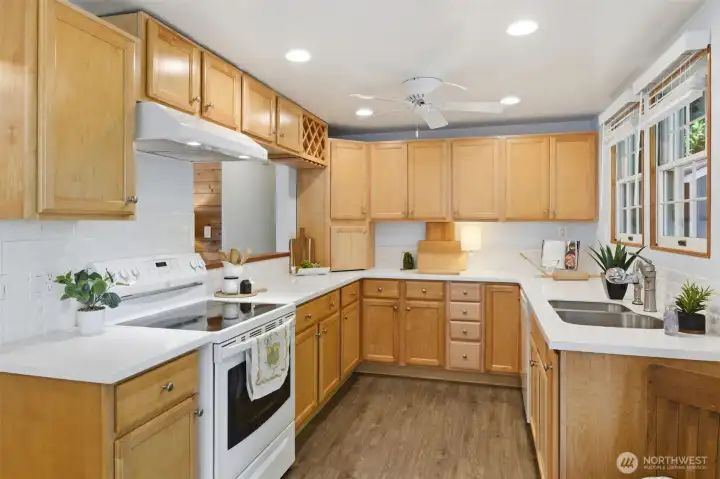 Fully equipped quartz kitchen with a multitude of specialized storage for discerning chef's tools and gadgets.