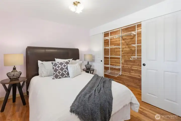 Primary bedroom has lighted cedar closet with organizing system.