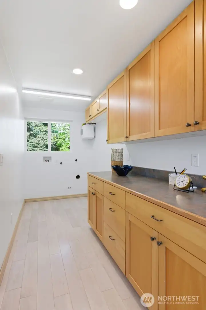 Generous storage and folding space in the laundry room located at the opposite end of the home office. Dedicated Bosch tankless waterheater for efficient water delivery to the washing machine!