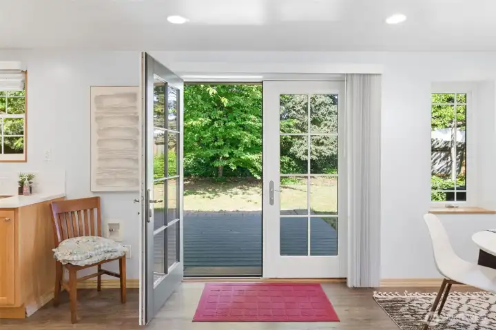French doors open to deck and lawns.