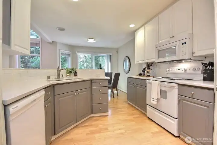 Fresh quartz countertops, a walk-in pantry, and a versatile peninsula make this kitchen as functional as it is beautiful. Fresh quartz countertops, a walk-in pantry, and a versatile peninsula make this kitchen as functional as it is beautiful.