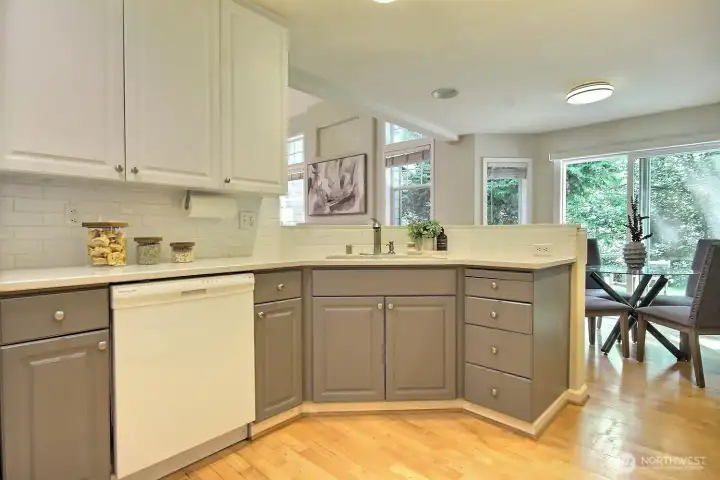 A stylish blend of contemporary and classic design, featuring sophisticated grey lower cabinets, timeless white uppers, and a crisp white tile backsplash. A stylish blend of contemporary and classic design, featuring sophisticated grey lower cabinets, timeless white uppers, and a crisp white tile backsplash.