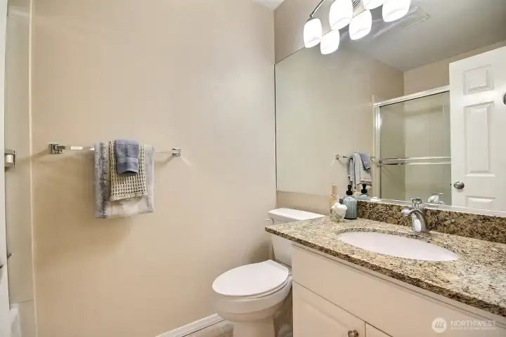 Guest room ensuite bath featuring granite countertops and tub/shower combo Guest room ensuite bath featuring granite countertops and tub/shower combo