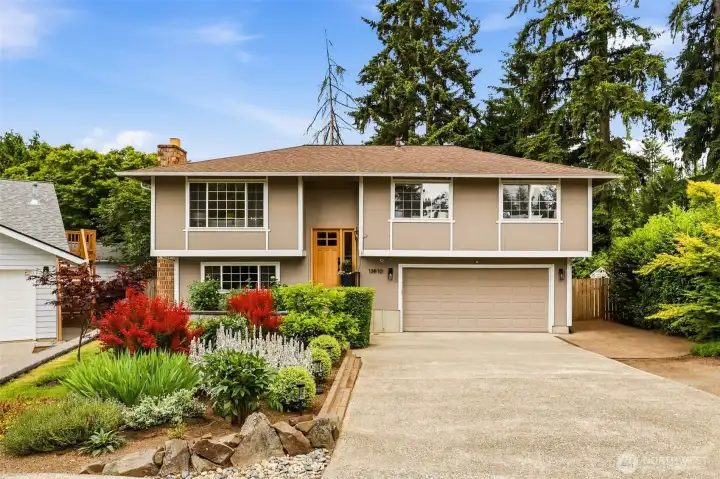 Stunning curb appeal with mature evergreen trees, lush landscaping, and a charming warm wood front door welcome you home. Stunning curb appeal with mature evergreen trees, lush landscaping, and a charming warm wood front door welcome you home.