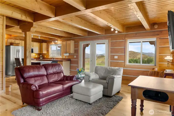 LivinGreat room with birch flooring, exposed beams & expansive mountain views.g room