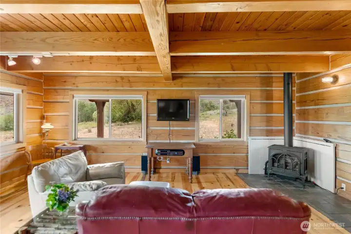 Open-concept living with walls of windows connecting the indoors to the outdoors.