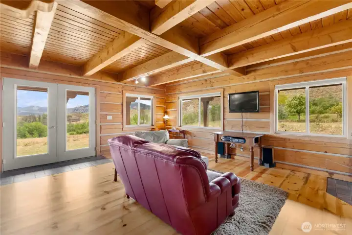 Open-concept living with walls of windows connecting the indoors to the outdoors.