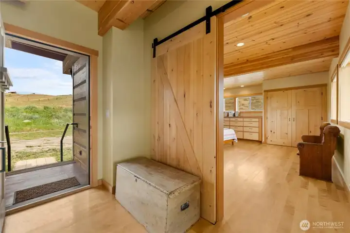 Welcoming formal entry with custom barn door.