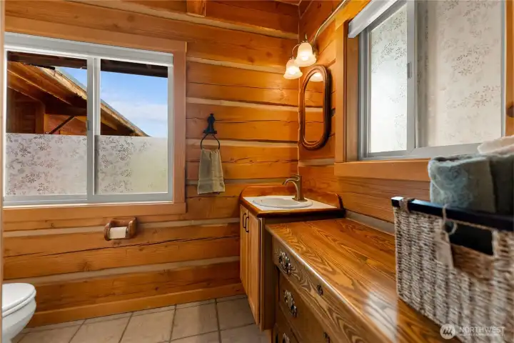 Main-floor bath with custom wood cabinetry & tile flooring.n floor bathroom