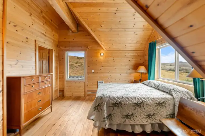 Rustic guest bedroom featuring warm wood finishes throughout.