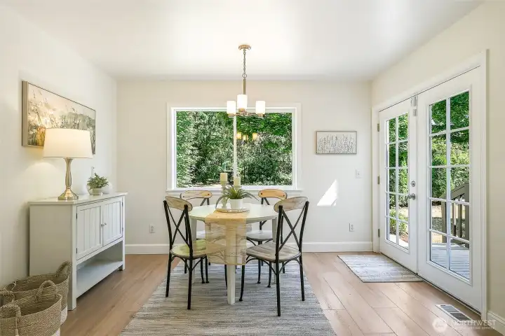 From a quiet dinner for two to a larger gathering, this open kitchen and dining area handles it all, with French doors leading to the deck