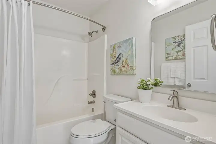 Full guest bathroom upstairs with tub/shower combo, new toilet, and updated fixtures