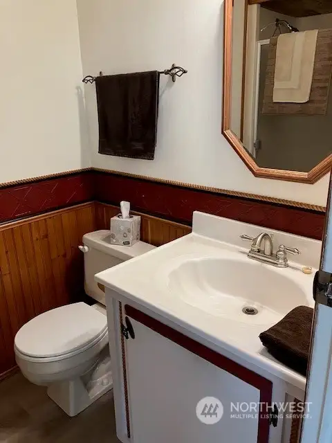 Main bath with updated flooring has shower and shelving shown in previous photo.
