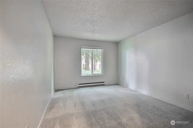 Bedroom with newer carpeting and paint in popular modern colors.