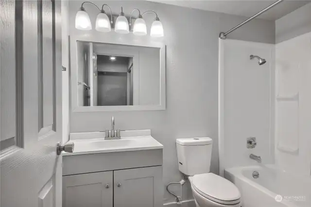 Updated bathroom with attractive modern bathroom and lighting fixures.