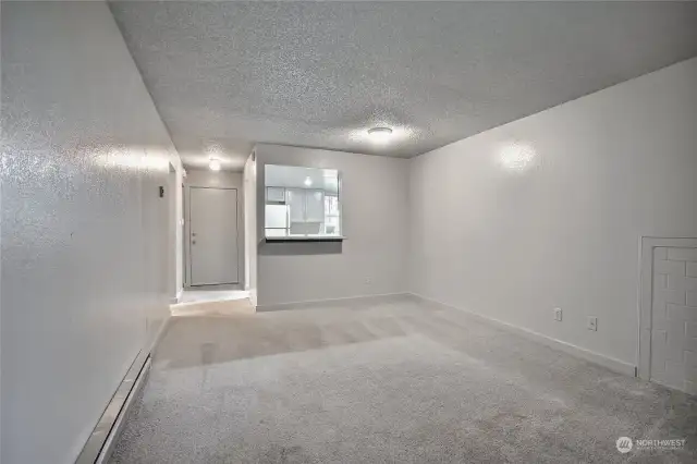 View from living room towards front entry with kitchen to the right.