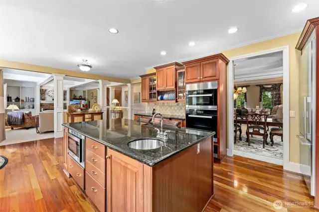 Note the double ovens, walk-in pantry, custom cabinetry and craftsman tiled full-height back splashes that make this home exceptionally livable and welcoming.