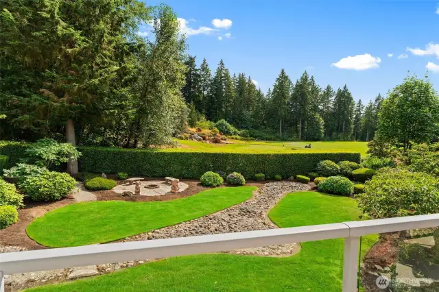 Perfect view of the picturesque 15th green from your main deck. The yard sits well behind and to the left of the green, plus is sheltered by an impressive hedge, which keeps stray golf balls out, even with such a world-class view.