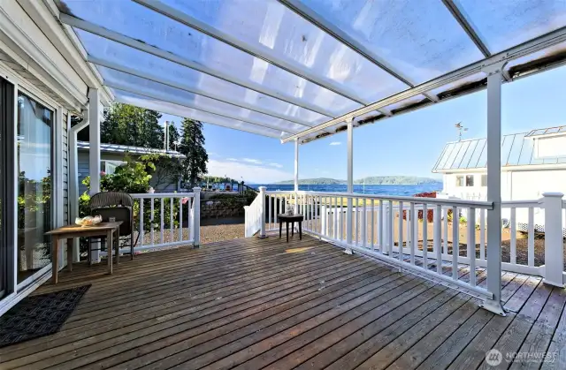 Covered deck with views of the canal and ramp access to the home