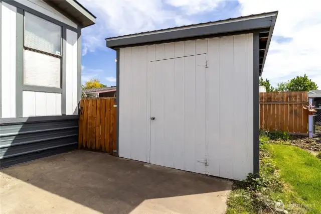 spacious storage shed with workbench and built-in shelving