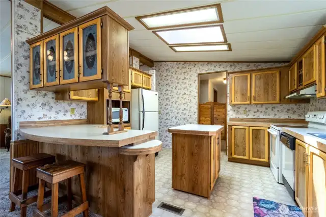 Kitchen with bar seating and an island with extra storage