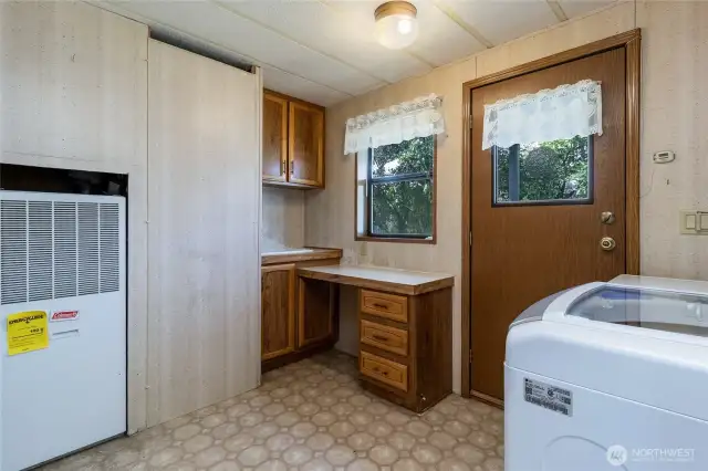 Laundry room with convenient work station and access to side porch entry.