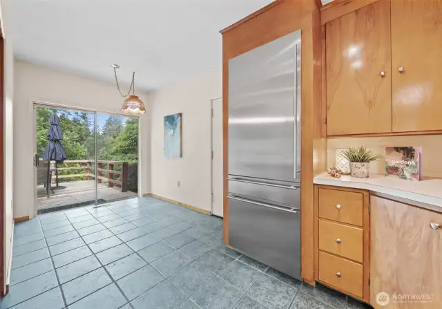 Stainless steel refrigerator. Kitchen nook for a desk or additional kitchen workspace.