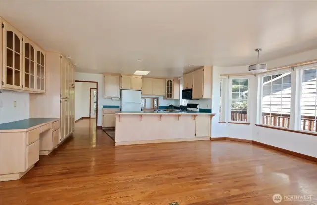 Open kitchen with eating bar and plenty of cabinets and storage.