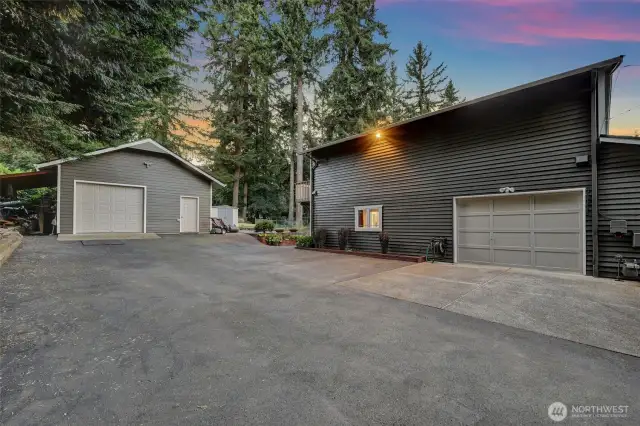 Detached garage and south side of the house at twilight.